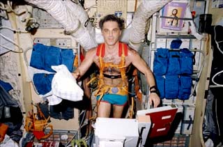 NASA-6 Mission Specialist David Wolf runs on a treadmill onboard the Base Block module of the Mir Space Station. 